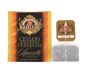 Basilur Ceylon Premium - czarna herbata cejlońska w ozdobnej, pomarańczowej kopercie z logo Basilur.