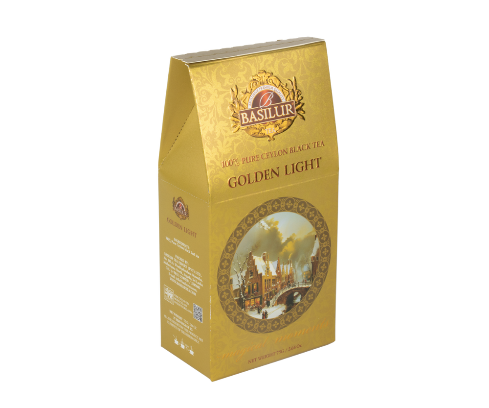 Herbata Basilur Golden Light w złotym pudelku z zimowym motywem.