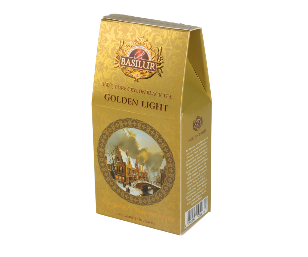 Herbata Basilur Golden Light w złotym pudelku z zimowym motywem.