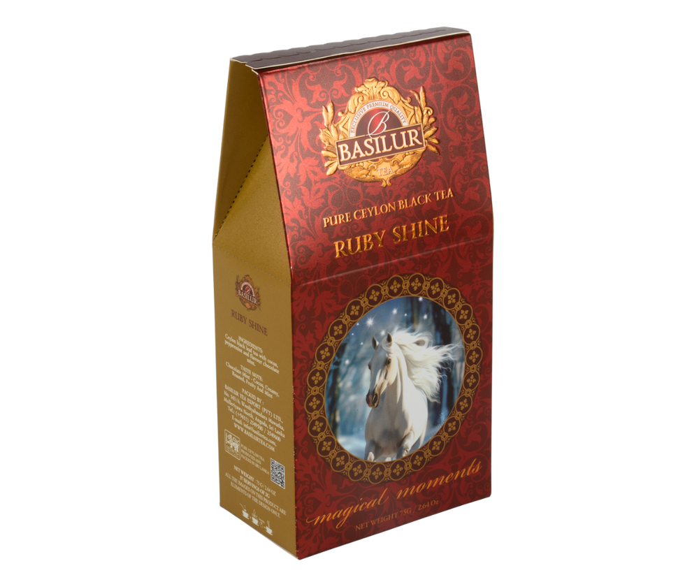 Herbata Basilur Ruby Shine w bordowym pudełku z motywem białego konia w zimowej scenerii.
